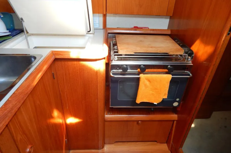 Slide: The Image of Galley kitchen in 1997 Jeanneau Sun Odyssey 36.2 sailboat with stove and sink. - 10