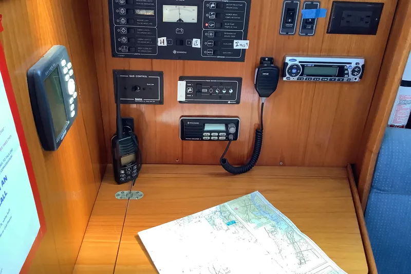 Slide: The Image of Navigation station on 1997 Jeanneau Sun Odyssey 36.2 with control panels and map. - 13