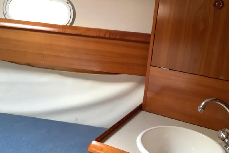 Slide: The Image of Interior of 1997 Jeanneau Sun Odyssey 36.2 yacht with wooden cabinetry and sink. - 15