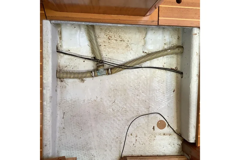 Slide: The Image of Bilge area of 1997 Jeanneau Sun Odyssey 36.2 sailboat with hoses and wiring. - 17