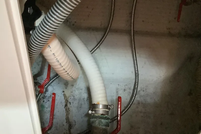 Slide: The Image of Bilge area of 1997 Jeanneau Sun Odyssey 36.2 with hoses and valves. - 18