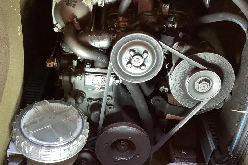Slide: The Image of Engine compartment of a 1997 Jeanneau Sun Odyssey 36.2 sailboat, showcasing belts and components. - 19