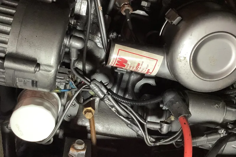 Slide: The Image of Engine components of a 1997 Jeanneau Sun Odyssey 36.2 sailboat, featuring wiring and filters. - 20