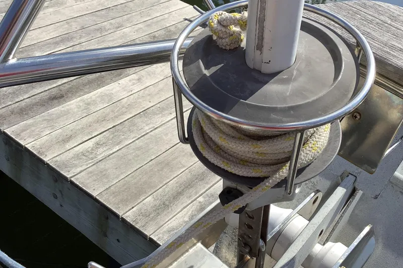 Slide: The Image of Rope coiled on Jeanneau Sun Odyssey 36.2 sailboat deck, near wooden dock. - 21