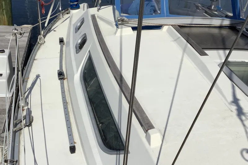 Slide: The Image of Deck view of a 1997 Jeanneau Sun Odyssey 36.2 sailboat, showcasing sleek design and windows. - 23