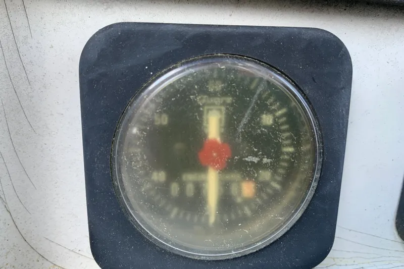Slide: The Image of Close-up of Jeanneau Sun Odyssey 36.2 compass, 1997 model, with a dusty glass cover. - 28