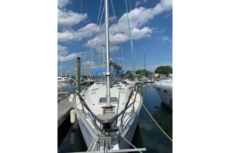 Slide: The Image of 1997 Jeanneau Sun Odyssey 36.2 sailboat docked at marina under blue sky. - 32