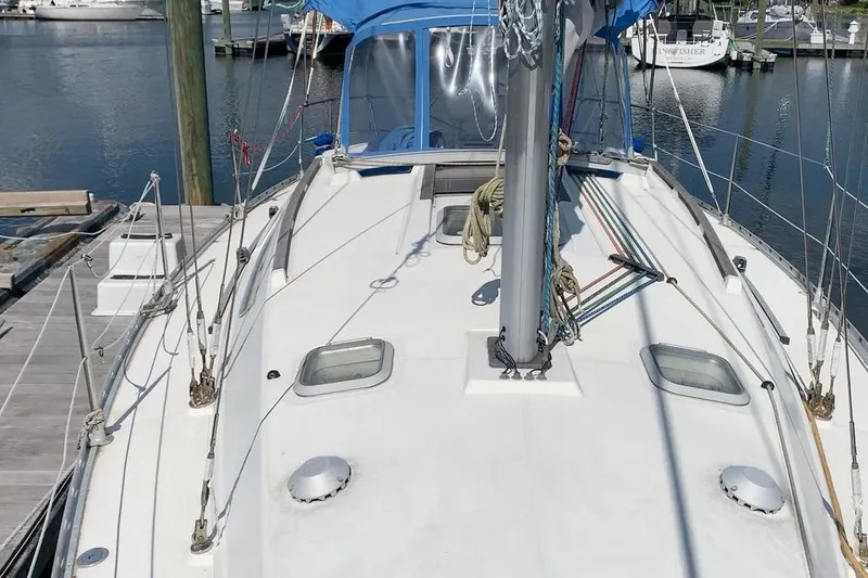 Slide: The Image of 1997 Jeanneau Sun Odyssey 36.2 sailboat docked at marina, showcasing deck and rigging. - 4