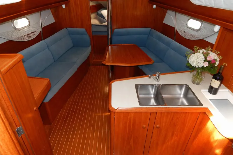 Slide: The Image of Interior of 1997 Jeanneau Sun Odyssey 36.2 yacht with wood finish and blue seating. - 5