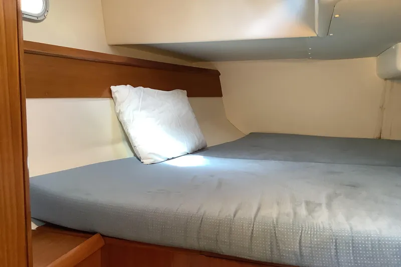 Slide: The Image of Cozy cabin interior of 1997 Jeanneau Sun Odyssey 36.2 sailboat with bed and pillow. - 6