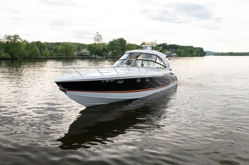 Slide: The Image of 2006 Formula 400 Super Sport boat cruising on a serene lake with lush greenery. - 4