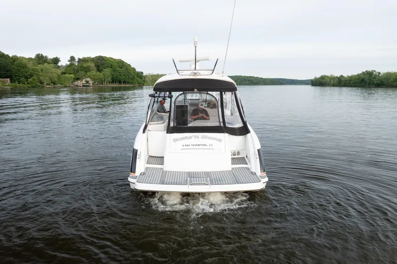 Slide: The Image of 2006 Formula 400 Super Sport boat cruising on a serene lake. - 7