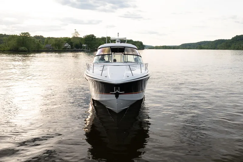 Slide: The Image of 2006 Formula 400 Super Sport boat on a serene lake, surrounded by lush greenery. - 8
