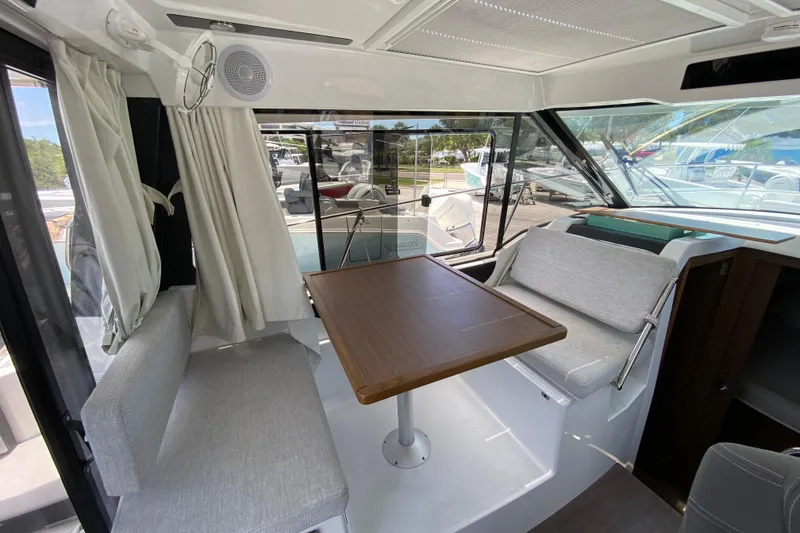 Slide: The Image of Interior of 2024 Jeanneau NC Weekender 895 Series 2, featuring a cozy dining area. - 10