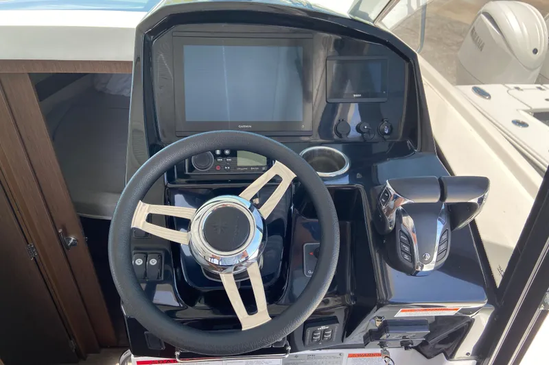Slide: The Image of Helm of 2024 Jeanneau NC Weekender 895 Series 2 with modern controls and displays. - 15