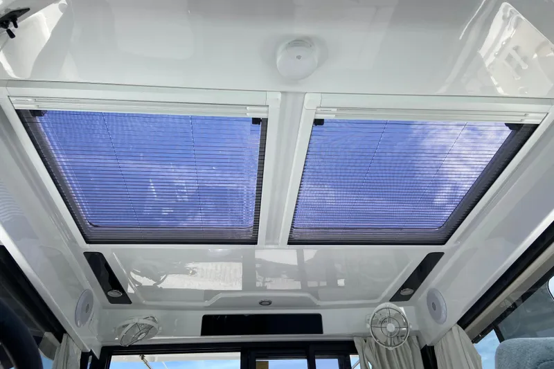 Slide: The Image of 2024 Jeanneau NC Weekender 895 Series 2 interior with skylight and blinds. - 24