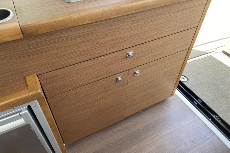 Slide: The Image of Wooden cabinetry inside 2024 Jeanneau NC Weekender 895 Series 2 boat. - 27