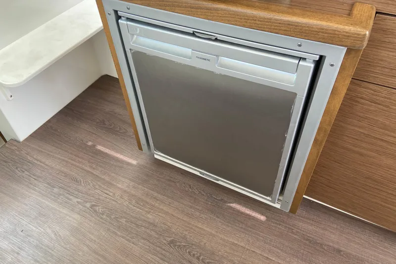 Slide: The Image of Compact refrigerator in 2024 Jeanneau NC Weekender 895 Series 2 boat interior. - 30