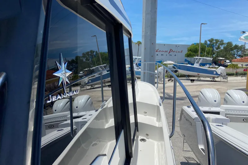 Slide: The Image of 2024 Jeanneau NC Weekender 895 Series 2 at marina, showcasing sleek design and branding. - 32