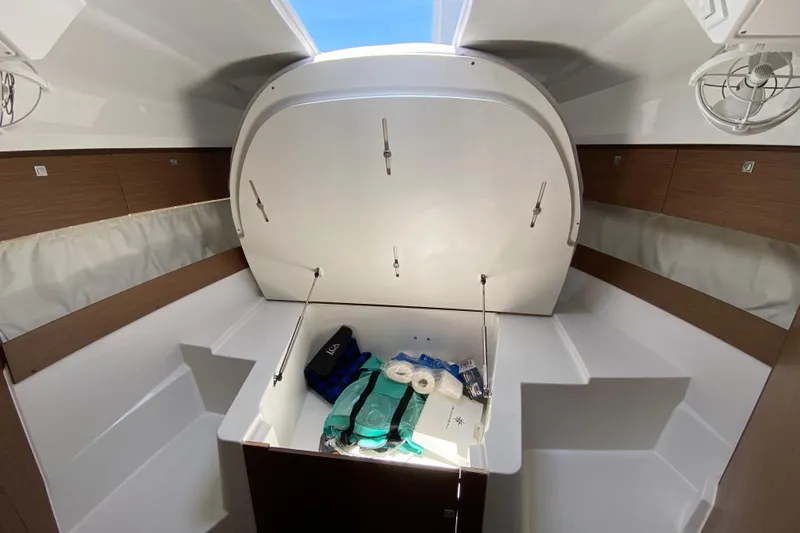 Slide: The Image of 2024 Jeanneau NC Weekender 895 Series 2 cabin interior with storage compartment open. - 36