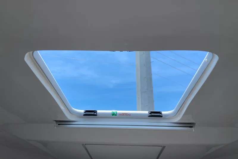 Slide: The Image of Skylight view from Jeanneau NC Weekender 895 Series 2, 2024 model, showcasing clear blue sky. - 40