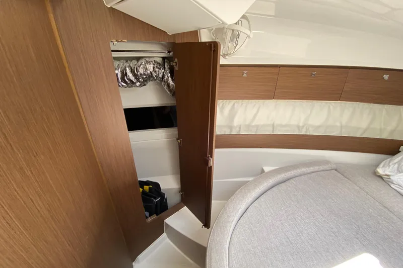 Slide: The Image of 2024 Jeanneau NC Weekender 895 Series 2 cabin interior with wood finish and storage. - 42