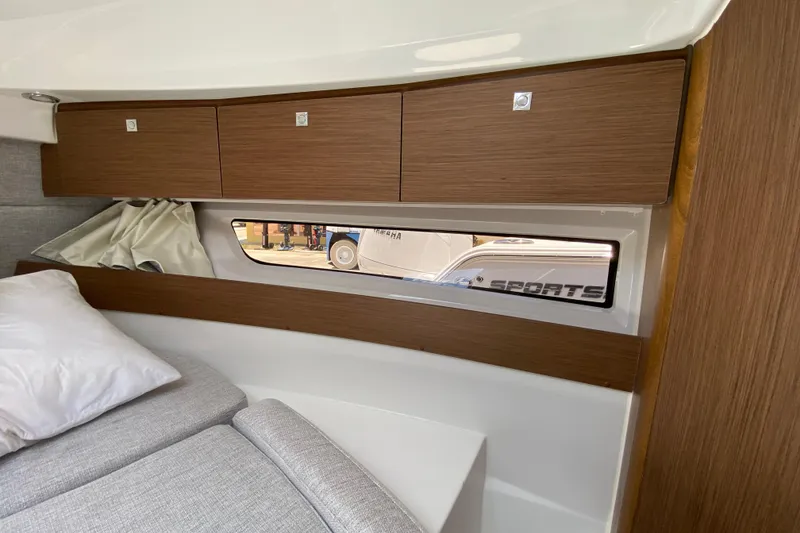 Slide: The Image of Interior cabin of 2024 Jeanneau NC Weekender 895 Series 2 with wood cabinets and window. - 43