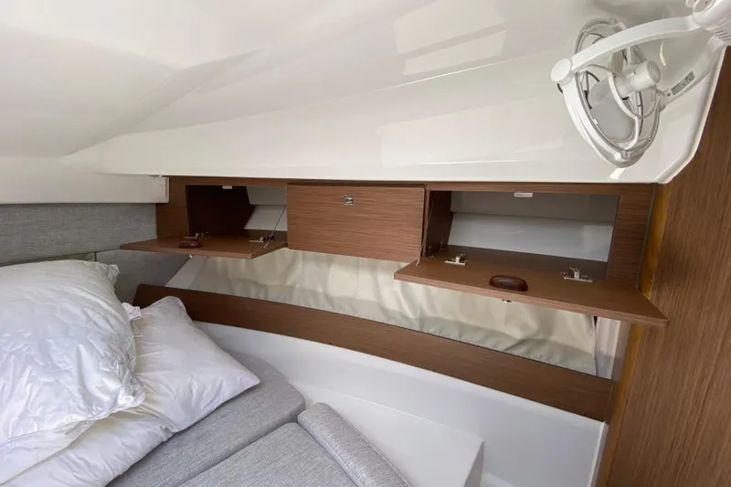 Slide: The Image of 2024 Jeanneau NC Weekender 895 Series 2 cabin with open wooden storage compartments. - 45