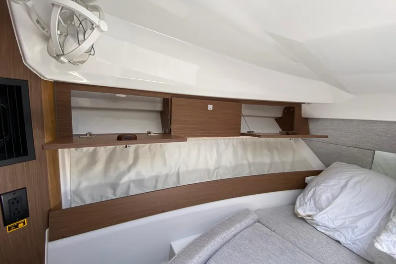 Slide: The Image of 2024 Jeanneau NC Weekender 895 Series 2 cabin interior with storage and bedding. - 49