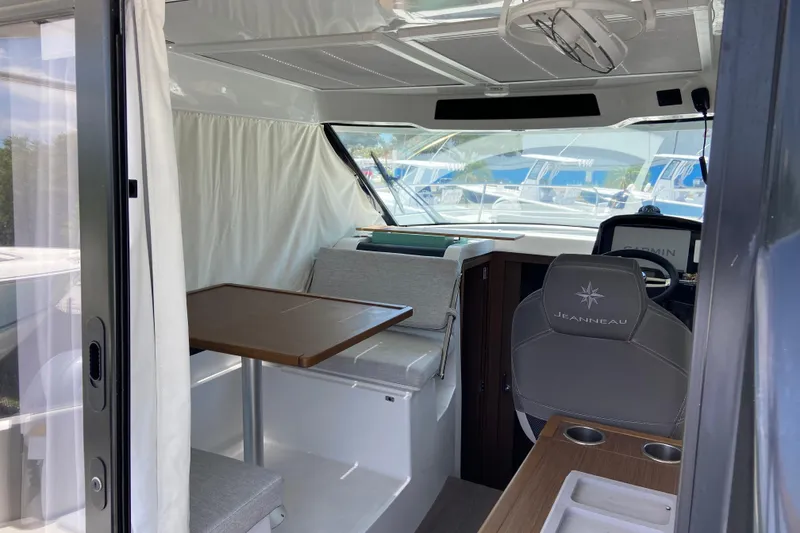 Slide: The Image of Interior of 2024 Jeanneau NC Weekender 895 Series 2, featuring seating and helm station. - 5