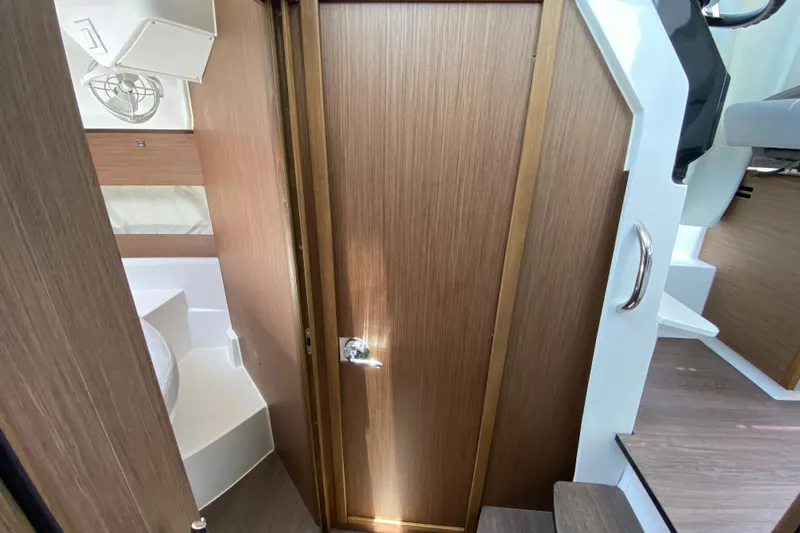 Slide: The Image of 2024 Jeanneau NC Weekender 895 Series 2 interior cabin with wooden door and modern design. - 51