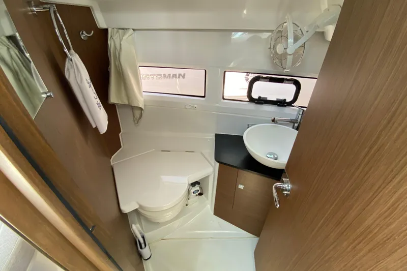 Slide: The Image of 2024 Jeanneau NC Weekender 895 Series 2 bathroom with modern fixtures and wood accents. - 52