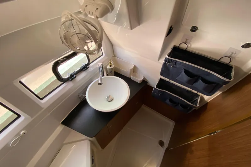 Slide: The Image of 2024 Jeanneau NC Weekender 895 Series 2 bathroom with sink, storage, and window. - 53