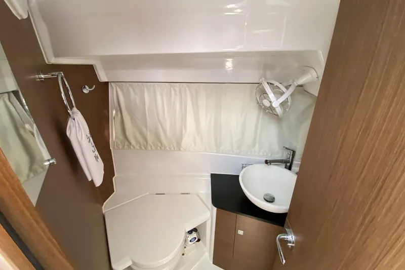 Slide: The Image of 2024 Jeanneau NC Weekender 895 Series 2 bathroom with sink, toilet, and fan. - 55