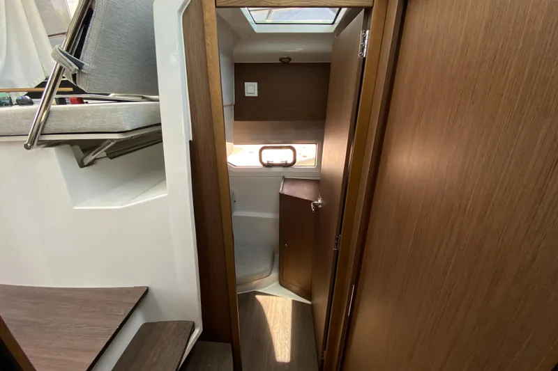 Slide: The Image of Interior view of 2024 Jeanneau NC Weekender 895 Series 2, featuring wooden finishes and compact design. - 56