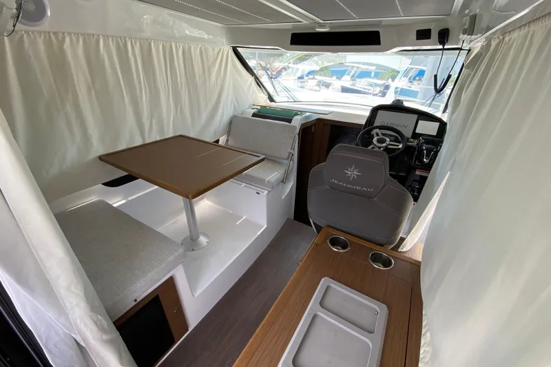 Slide: The Image of Interior of 2024 Jeanneau NC Weekender 895 Series 2, featuring helm and seating area. - 6