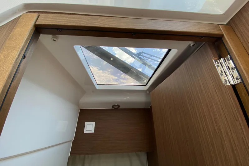 Slide: The Image of Interior view of 2024 Jeanneau NC Weekender 895 Series 2 with skylight and wooden finish. - 60