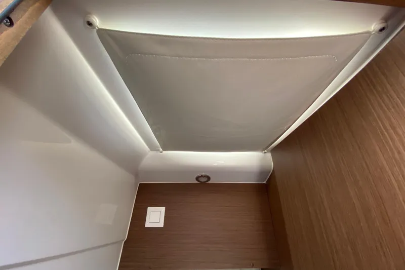 Slide: The Image of Interior view of 2024 Jeanneau NC Weekender 895 Series 2, featuring sleek wood paneling. - 61