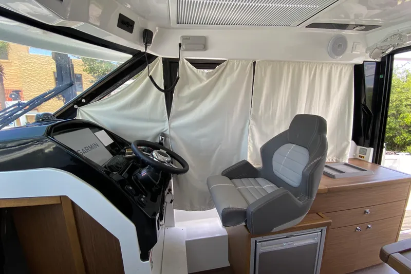 Slide: The Image of Interior helm of 2024 Jeanneau NC Weekender 895 Series 2 with modern steering and seating. - 8