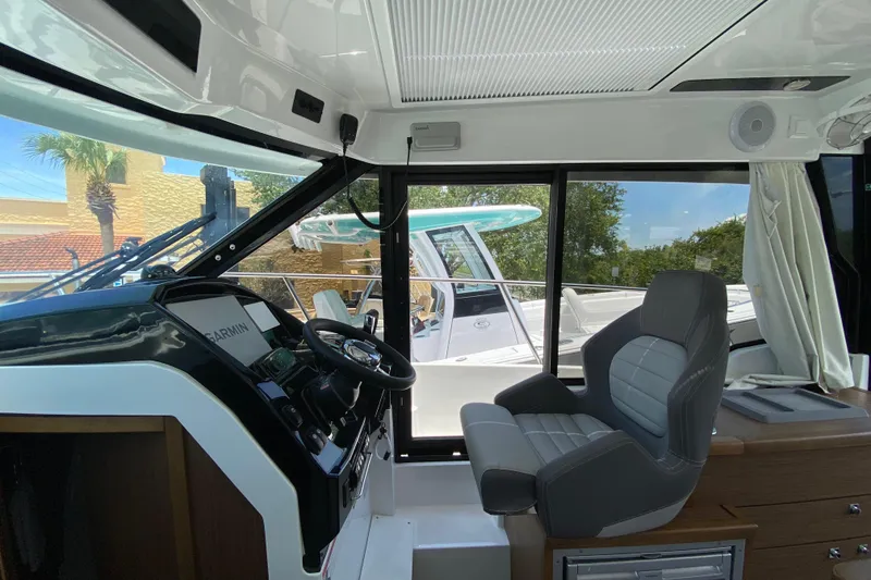 Slide: The Image of Interior view of 2024 Jeanneau NC Weekender 895 Series 2 boat cockpit with modern controls. - 9