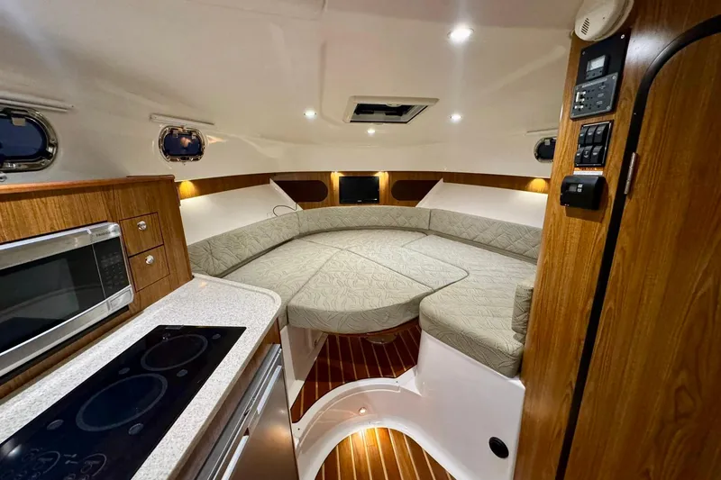 Slide: The Image of Interior of 2014 Pursuit OS 345 Offshore boat with cozy seating and modern amenities. - 19