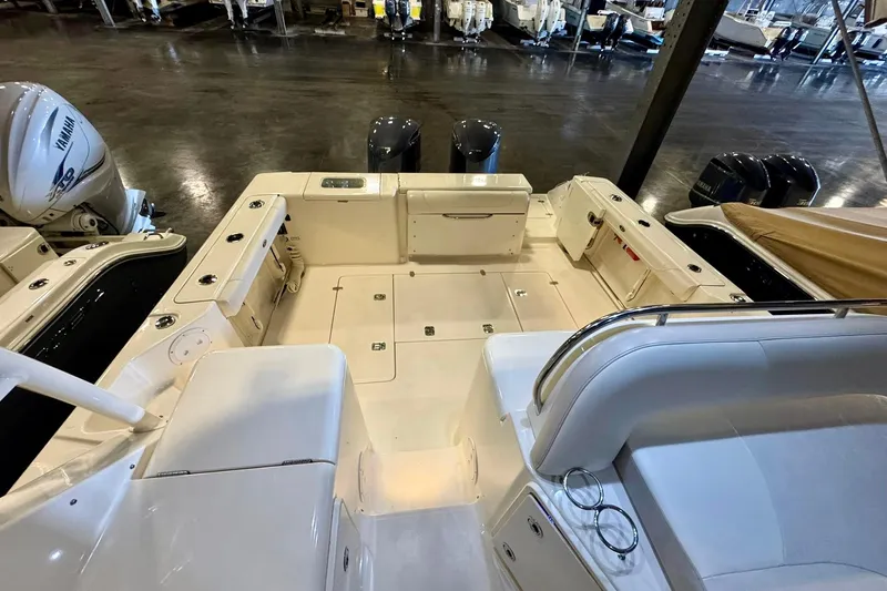 Slide: The Image of 2014 Pursuit OS 345 Offshore boat interior with Yamaha engines in a showroom. - 6