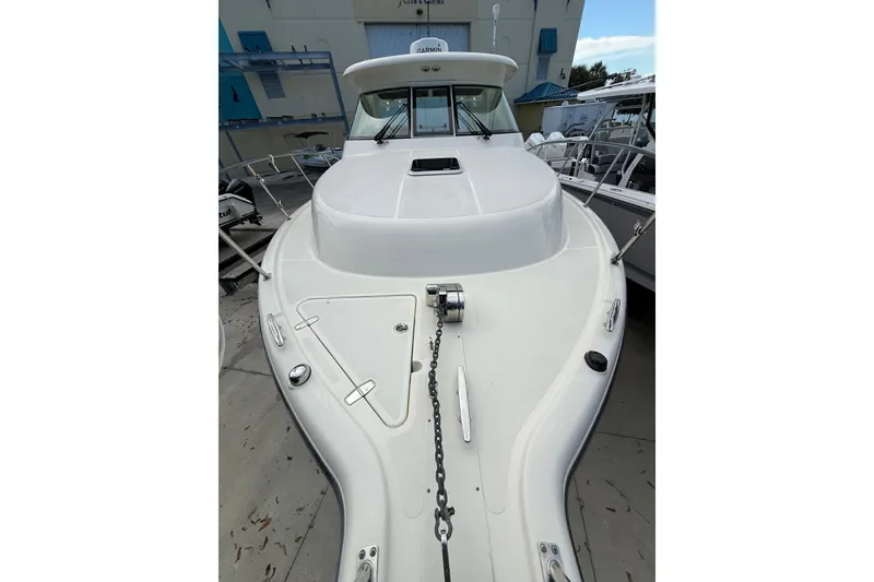 Slide: The Image of 2014 Pursuit OS 345 Offshore boat, white deck view, docked at marina. - 3
