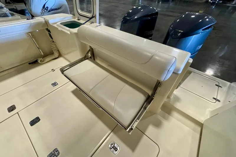 Slide: The Image of 2014 Pursuit OS 345 Offshore boat interior with foldable seat and Yamaha engines. - 10