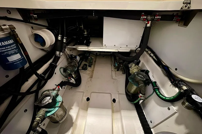 Slide: The Image of Engine compartment of a 2014 Pursuit OS 345 Offshore boat, showcasing fuel and water systems. - 22
