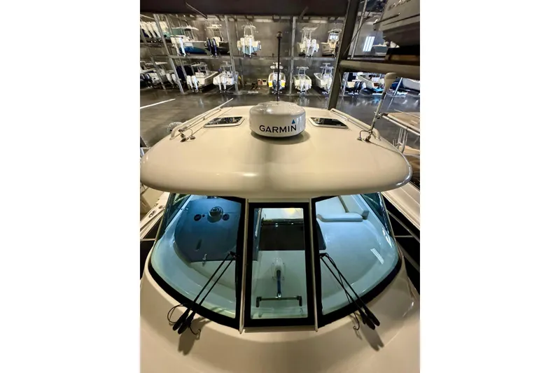 Slide: The Image of 2014 Pursuit OS 345 Offshore boat with Garmin radar in storage facility. - 24