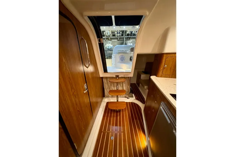Slide: The Image of Interior of 2014 Pursuit OS 345 Offshore boat with wooden flooring and cabinetry. - 20