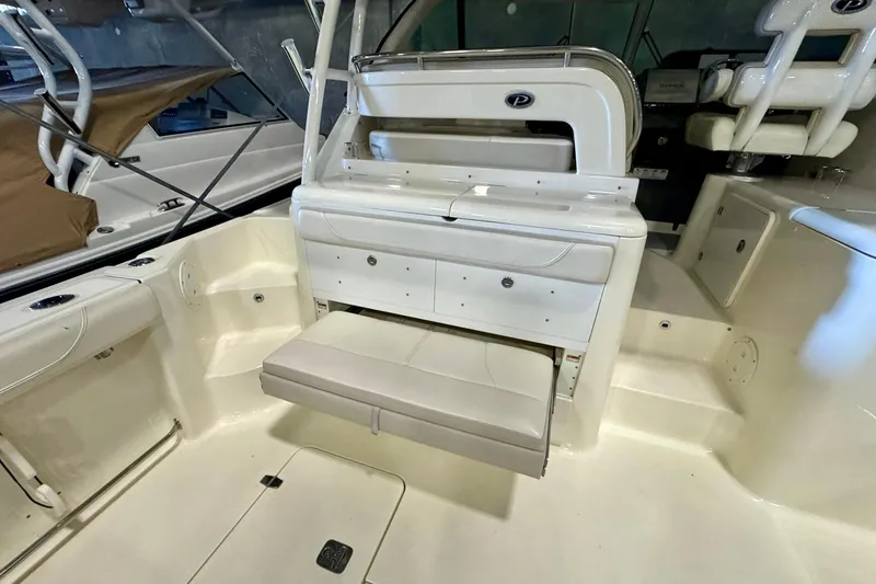 Slide: The Image of 2014 Pursuit OS 345 Offshore boat interior with seating and storage compartments. - 16