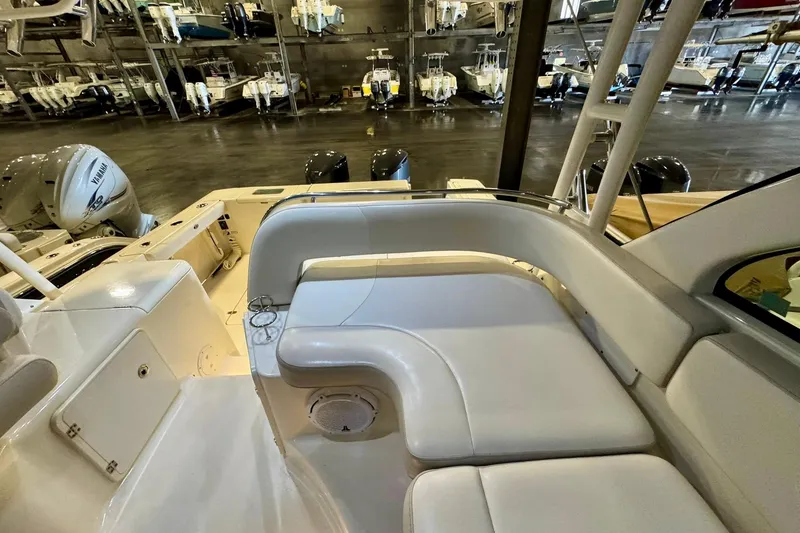 Slide: The Image of 2014 Pursuit OS 345 Offshore boat interior with white seating and Yamaha engines in storage. - 4