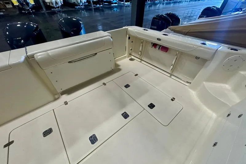 Slide: The Image of 2014 Pursuit OS 345 Offshore boat deck with storage compartments and seating. - 8